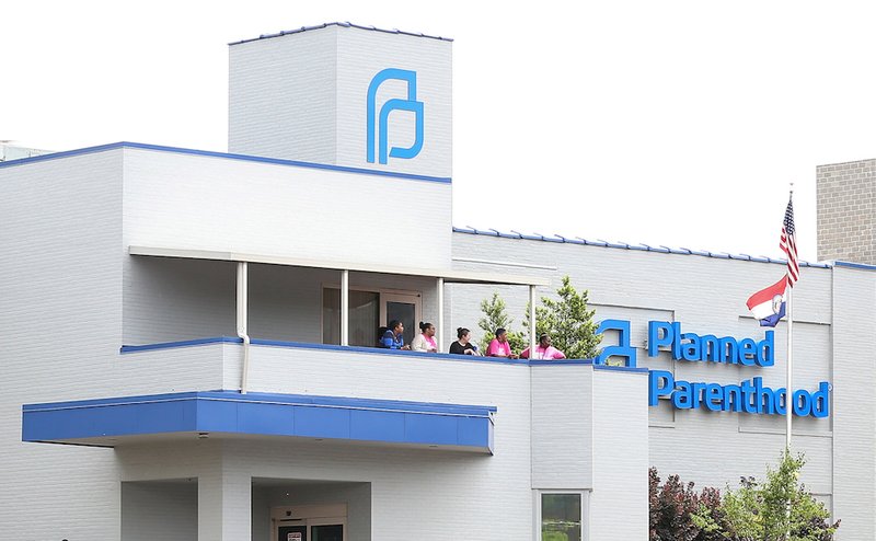 Planned Parenthood employees stand outside the facility during protests in St. Louis May 31