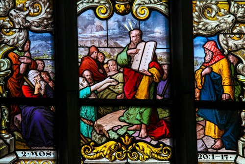 Stained glass window depicting Moses showing the Stone Tablets with the Ten Commandments