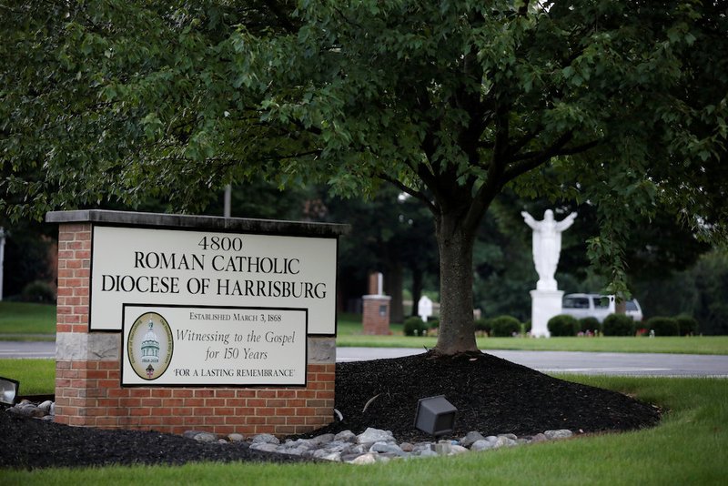 A statue of Christ and a sign are seen in late August at the entrance to the Diocese of Harrisburg in Pennsylvania. The Justice Department said in mid-October it was opening its own investigation into Pennsylvania's Catholic dioceses and clergy sex abuse claims. (CNS photo/Carlos Barria