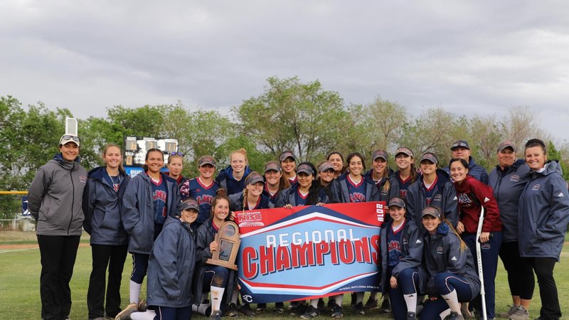 The LMU softball team and coaches display their NISC Region championship banner after winning the regional May 18 in Stockton. (LMU ATHLETICS)