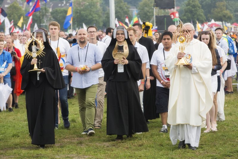Relics of Sts. Faustina Kowalska and John Paul II are carried into the opening Mass for World Youth Day in Krakow