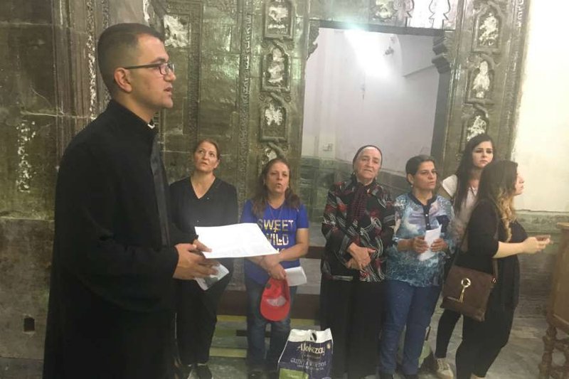 Father Momika leads a group of women touring Mar Behnam Monastery in Iraq October 2017