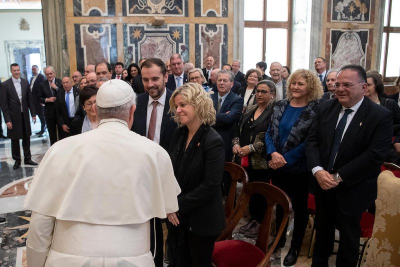 Pope Francis greets people during an audience with members of the Confraternity of Nuestra Senora de la Cinta (Our Lady of the Ribbon) from Tortosa