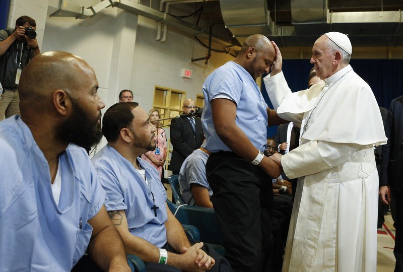 Pope Francis blesses a prisoner as he visits the Curran-Fromhold Correctional Facility in Philadelphia in 2015. (CNS photo/Paul Haring)