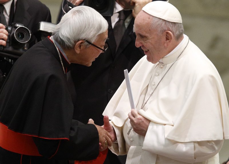 Pope Francis holds a letter presented by Cardinal Joseph Zen Ze-kiun