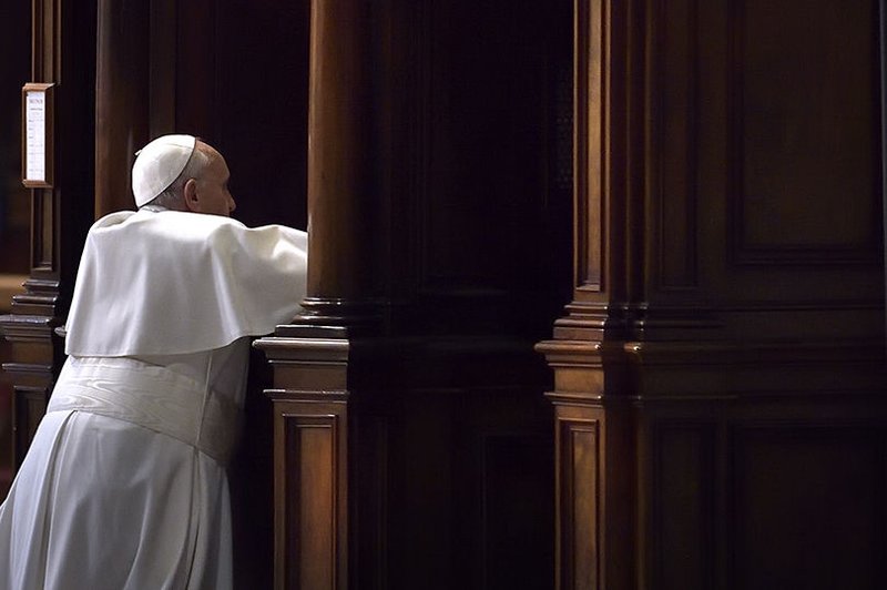 Pope Francis goes to confession during a Lenten penance service in St. Peter’s Basilica at the Vatican March 13