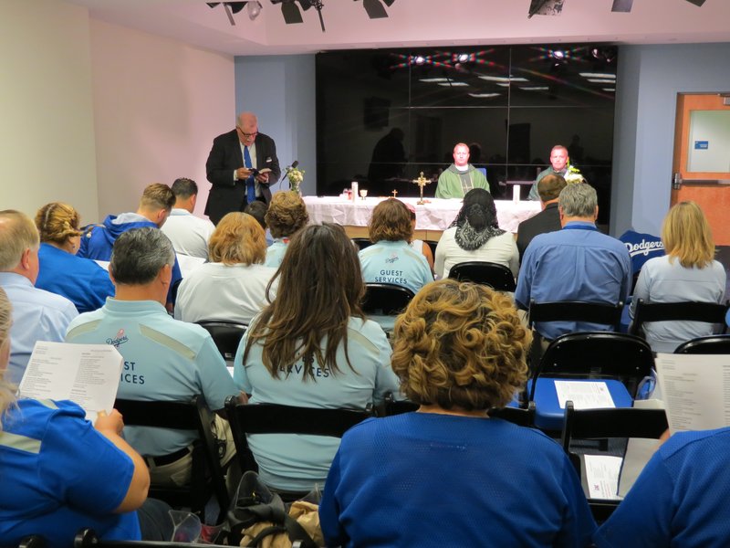 Brian Golden proclaims a reading during a Mass at the Vin Scully/Billy DeLury Chapel in 2016. The interview room is used for Dodger manager Dave Roberts’ post-game media briefings. (CATHOLIC ATHLETES FOR CHRIST)