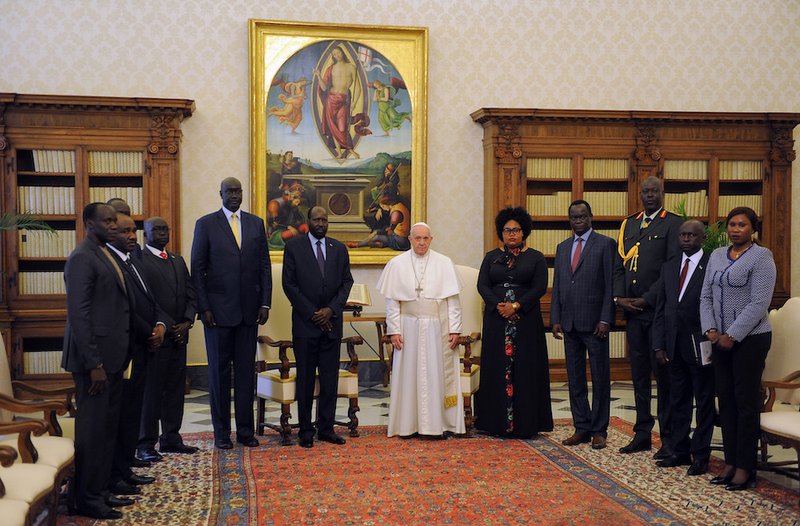 Pope Francis poses with President Salva Kiir of South Sudan and his delegation during a private audience at the Vatican March 16