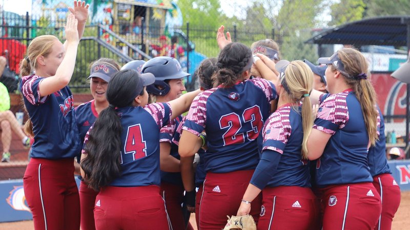 The LMU softball team celebrates its May 24 victory in the NISC Tournament May 24 in Colorado. (LMU ATHLETICS)