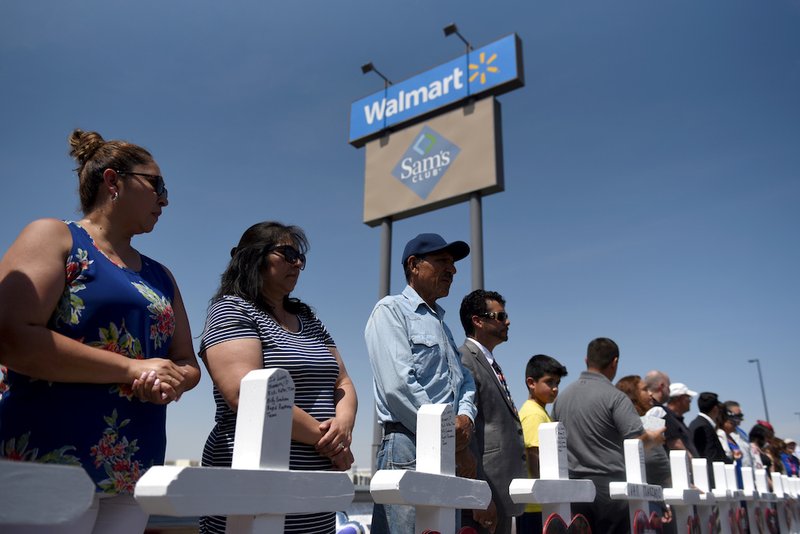 People stand near crosses Aug. 5