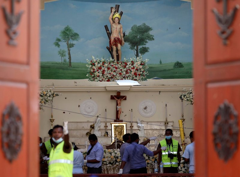 Police officers work the scene at St. Sebastian Catholic Church in Negombo