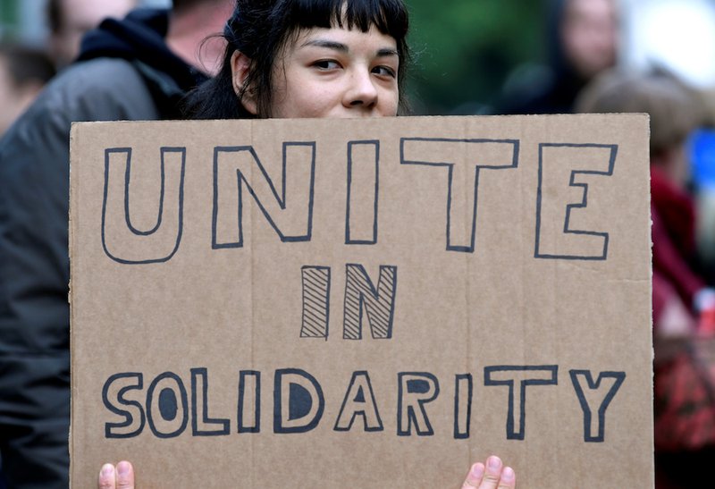 A woman holds a placard during a demonstration called "No fascism in Belgium or in Europe!" outside the European Parliament in Brussels May 28