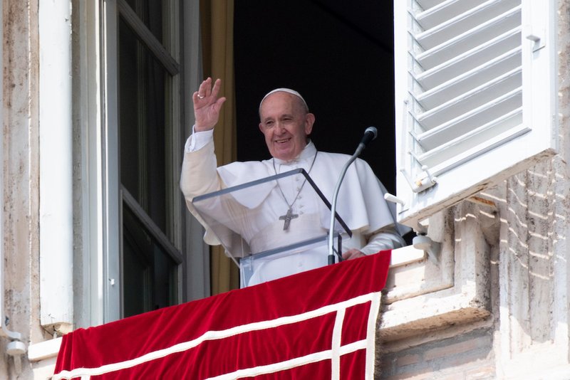 Pope Francis greets the crowd as he leads the Angelus from the window of his studio overlooking St. Peter's Square at the Vatican Sept. 1