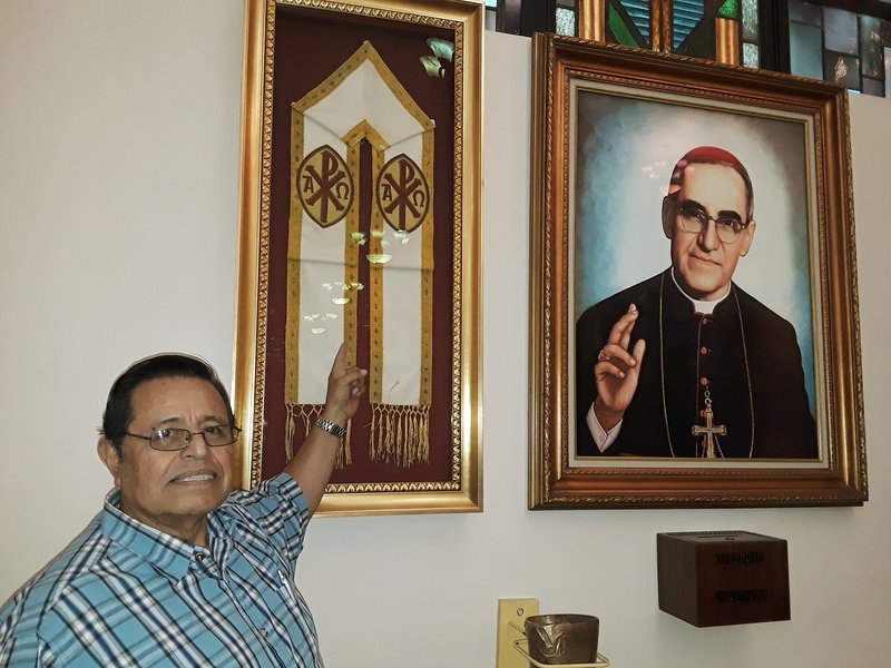 Oscar Vazquez with a stole used by Archbishop Romero on display at St. Patrick's Church in North Hollywood. (PILAR MARRERO/ANGELUS). 