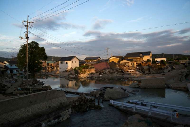 Houses sit partially submerged in floodwater in Kurashiki