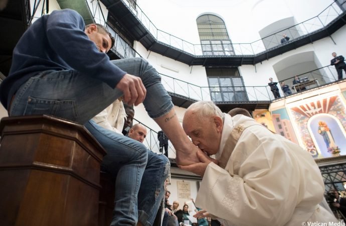 Pope Francis washes the feet of inmates during his visit to the Regina Coeli detention center in Rome