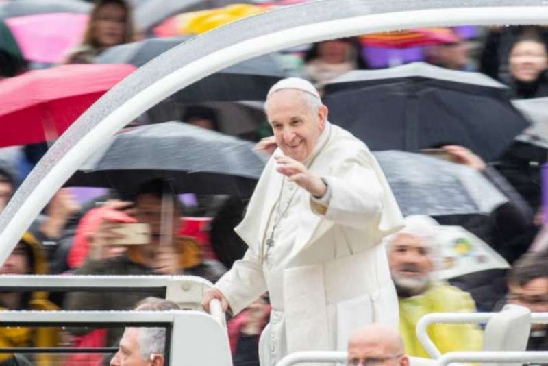 Pope Francis waves at the general audience