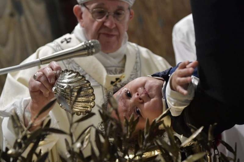 Pope Francis baptizes a baby in the Sistine Chapel Jan. 13