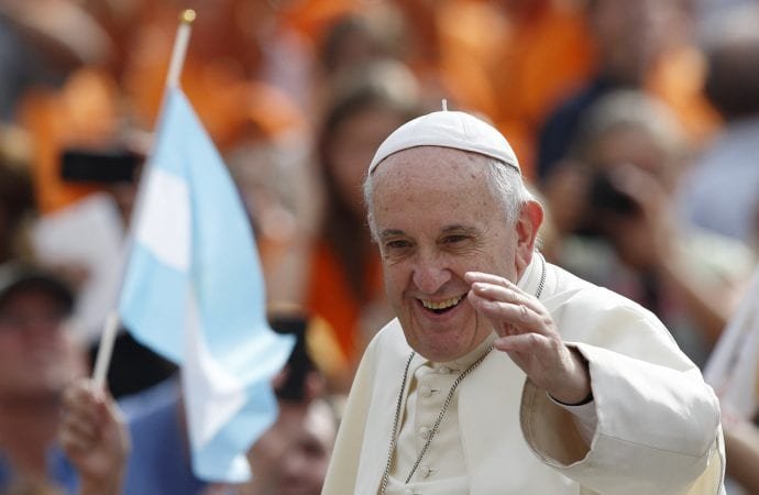 A pilgrim waves Argentina's flag as Pope Francis arrives to lead his general audience in St. Peter's Square at the Vatican Sept. 2. (CNS photo/Paul Haring via Crux)