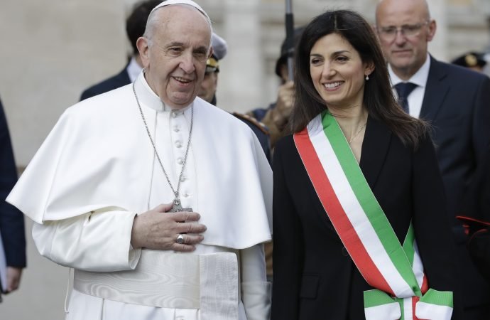 Pope Francis is welcomed by Rome's mayor Virginia Raggi during his visit to the Rome's city hall