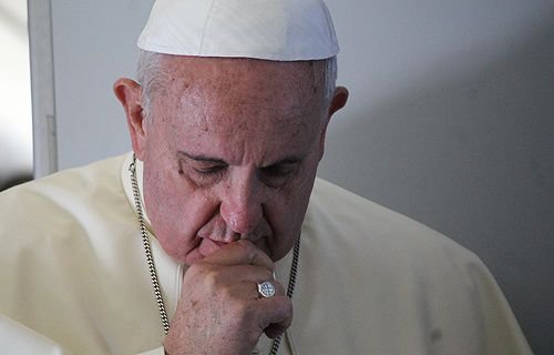 Pope Francis on the papal flight to South Korea on Aug. 14