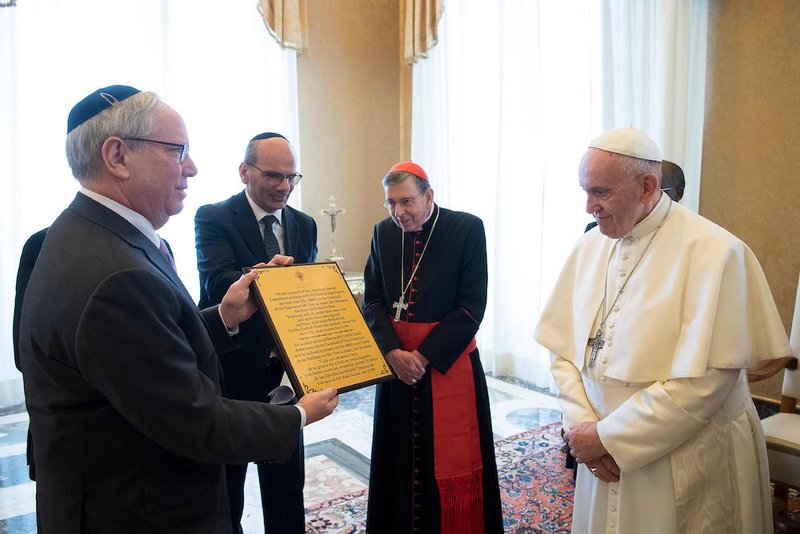 A representative of the American Jewish Committee gives Pope Francis a certificate March 8