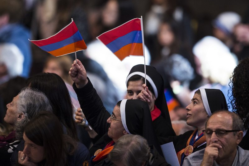 Women religious wave the Armenian flag in St. Peter's Basilica at the Vatican in this 2015 file photo. (CATHOLIC NEWS SERVICE/CRISTIAN GENNARI)