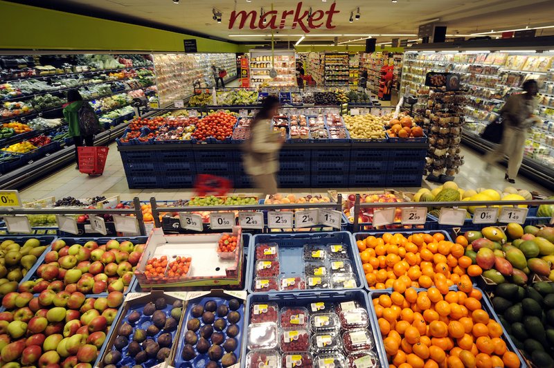 Customers visit the fruit and vegetables department of a grocery store in Brussels Sept. 4
