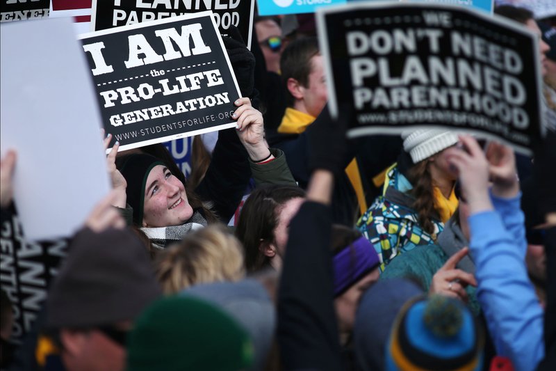 Pro-life advocates hold signs during the 2017 March for Life in Washington. (CNS photo/Tyler Orsburn)