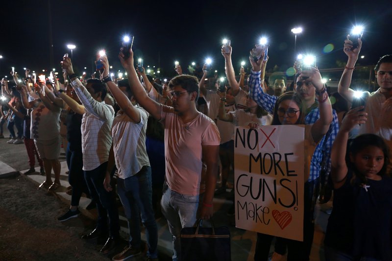 Mourners take part in a vigil near the border fence between Mexico and the U.S. after a mass shooting at a Walmart store in El Paso