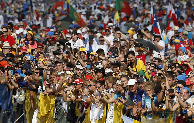 The crowd reacts as Pope Francis arrives to celebrate the closing Mass of World Youth Day at Campus Misericordiae in Krakow