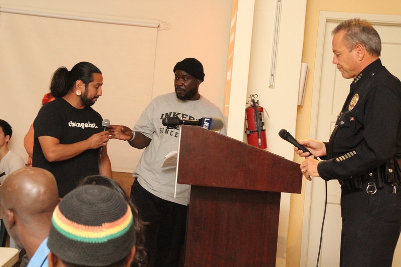 Mario Fedelin of Invest in Youth Coalition prepares to discuss change with Chief Moore. (FATHER ROBERT DOLAN/LA VOICE)