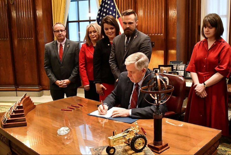 Missouri Gov. Mike Parson signs a bill into law banning abortion beginning in the eighth week of pregnancy