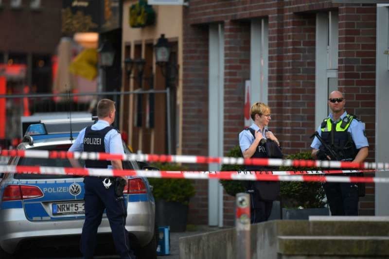 Police stand near the site of a van attack on a crowd of pedestrians in Muenster