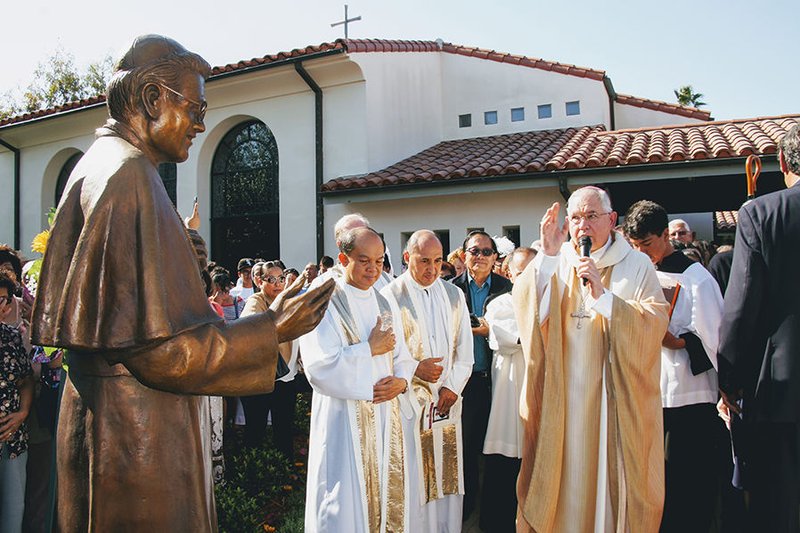 Archbishop José H. Gomez blesses a statue of Bishop Alphonse Gallegos in the garden of St. Augustine Priory in Oxnard June 24