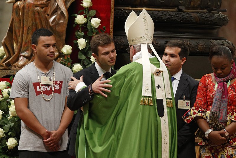 Pope Francis greets synod observers during the closing Mass of the Synod of Bishops on young people