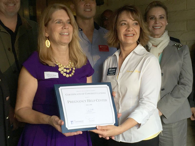 Pregnancy Help Center director Adrienne Gross receives a certificate from the Torrance Chamber of Commerce to celebrate their 40 years of service to the community. (courtesy photo)