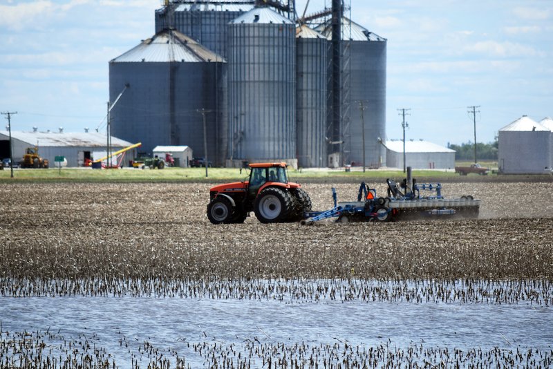 Standing water is seen near a tractor in Woodford County