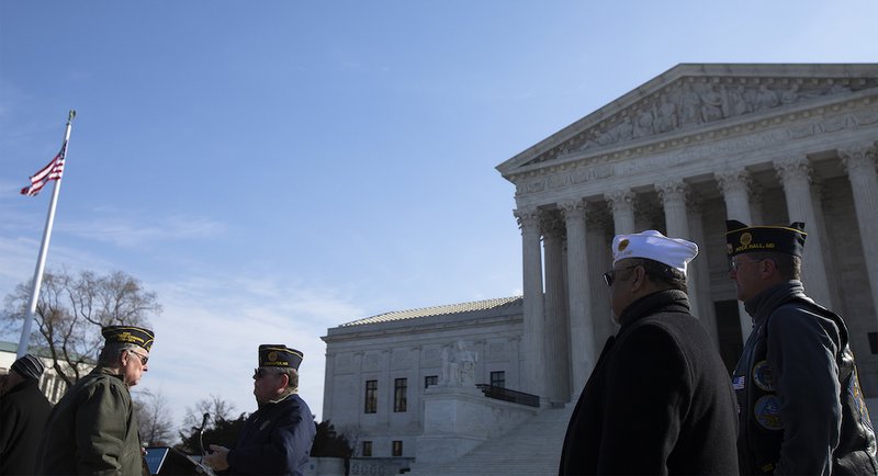 Military veterans are seen near the U.S. Supreme Court in Washington Feb. 27