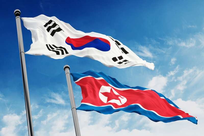 The flags of North and South Korea. Credit: cigdem/Shutterstock.