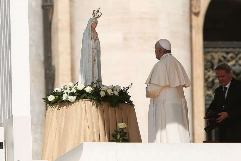 Pope Francis prays before a statue of Our Lady of Fatima May 13