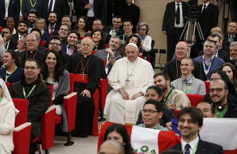 Pope Francis poses for a photo at a pre-synod gathering of youth delegates at the Pontifical International Maria Mater Ecclesiae College in Rome March 19. (CNS photo/Paul Haring)