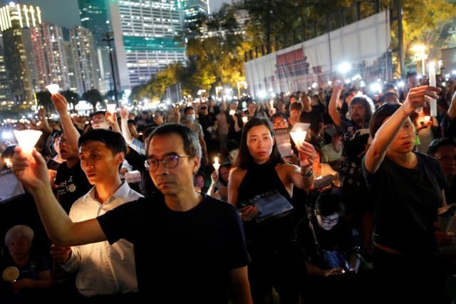 Thousands of people take part in a candlelight vigil at Victoria Park in Hong Kong June 4