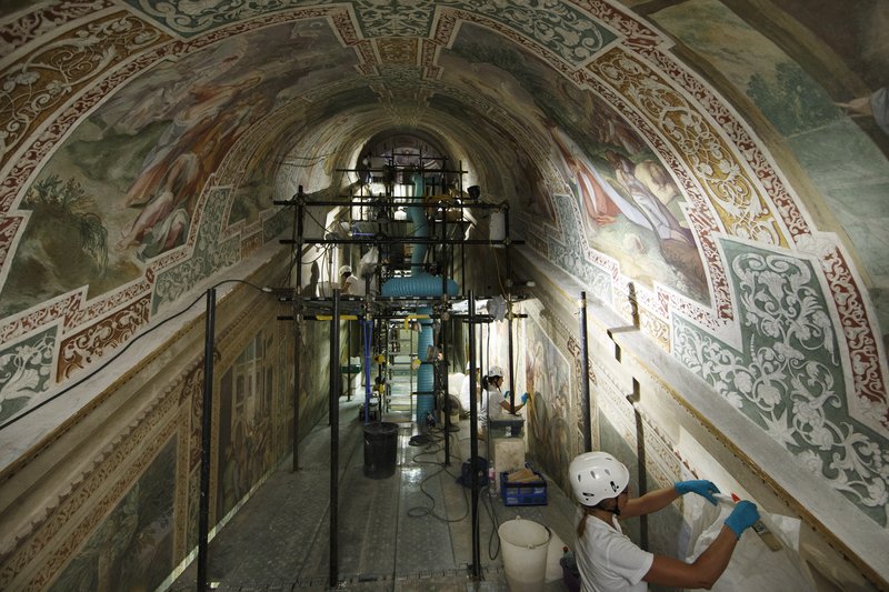 Workers restore the frescoes surrounding the Holy Stairs at the Pontifical Sanctuary of the Holy Stairs in Rome July 10. Vatican restorers are completing the final phase of a 20-year effort to restore 16th-century artwork at the sanctuary. (CNS photo/Paul Haring)