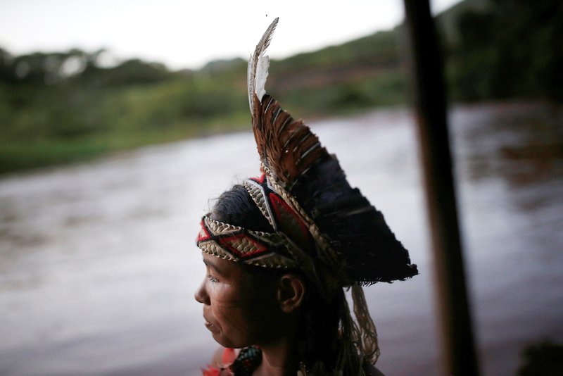 An indigenous woman from the Pataxo Ha-ha-hae tribe looks over the Paraopeba River in Brazil Jan. 28