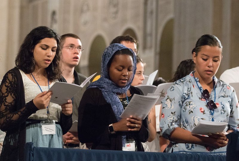 Young people pray at the Basilica of the National Shrine of the Immaculate Conception in Washington July 22. More than 1