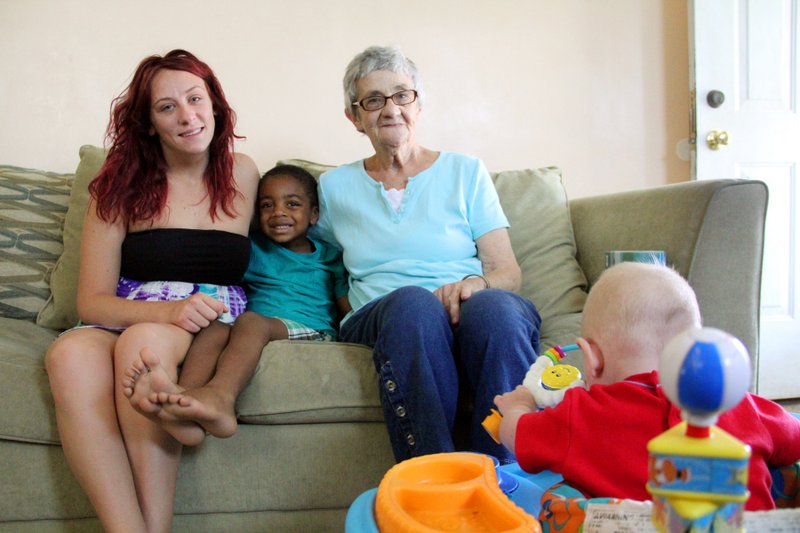 Cecilia Paul sits with daughter Taylor and her son