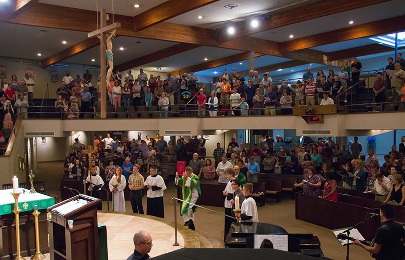 Gospel lectionary being processed to the altar at the beginning of Mass (photo: Kevin Theriault)