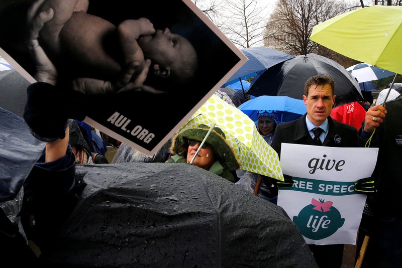 A pro-life advocate holds a sign during a March 20 rally outside the U.S. Supreme Court in Washington as the court hears oral arguments in NIFLA v. Becerra. (CNS photo/Jonathan Ernst