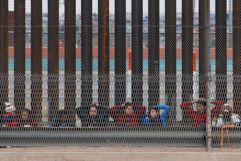 Migrants from Central America are being escorted by U.S. Customs and Border Protection officials after crossing the border from Mexico to surrender to the officials in El Paso